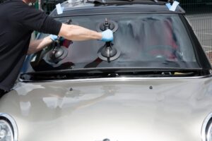 A person is installing a new windshield