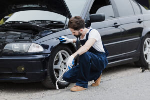 full shot man crouched car