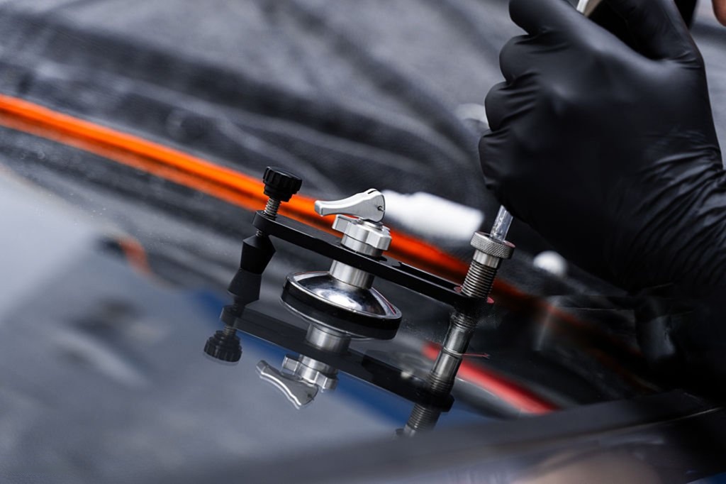 Windshield crack repair using resin injection.