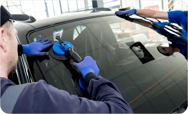 2 people replacing windshield