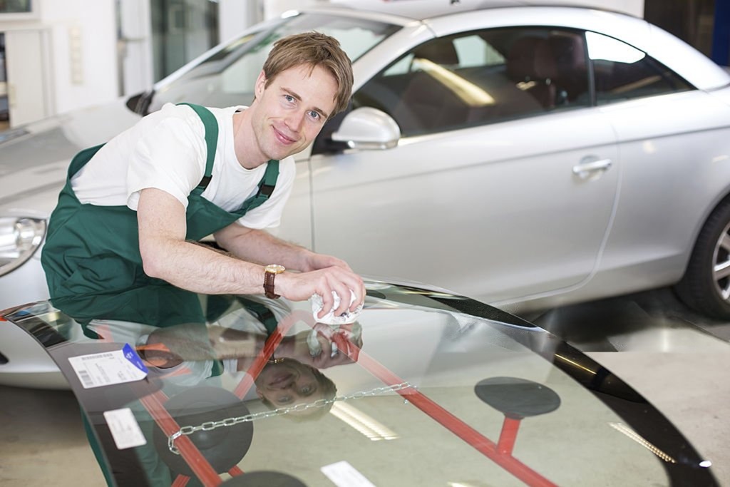 Glazier with car windshield made of glass