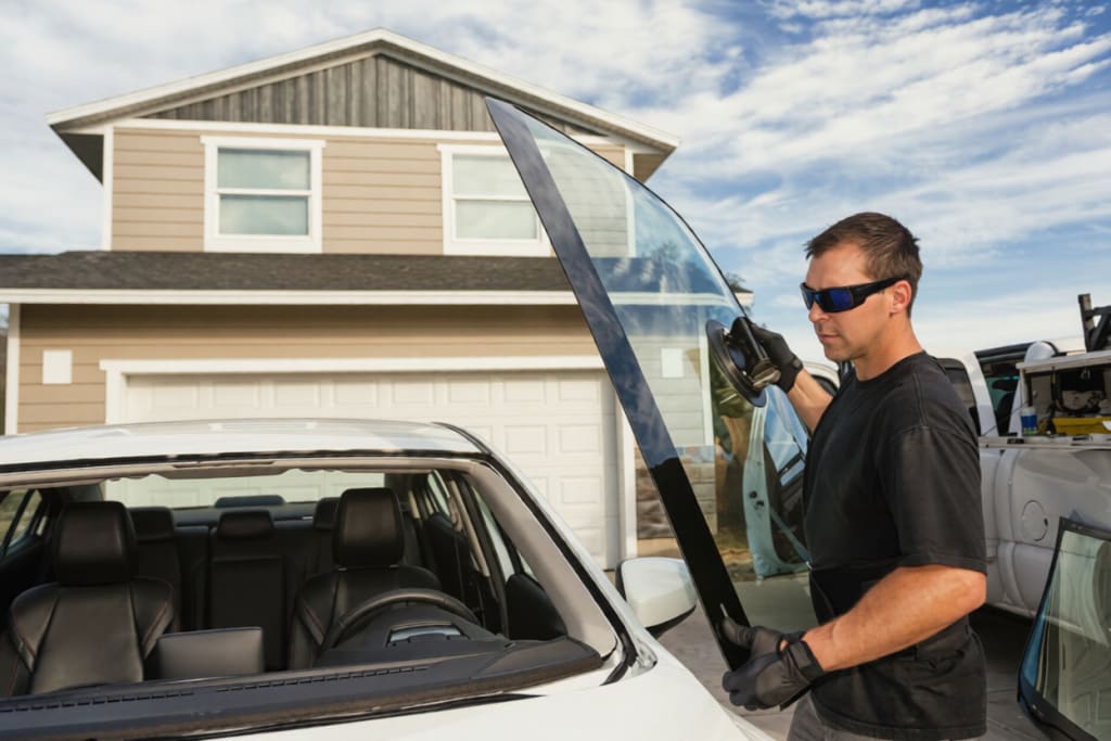 A man replacing Car Windshield