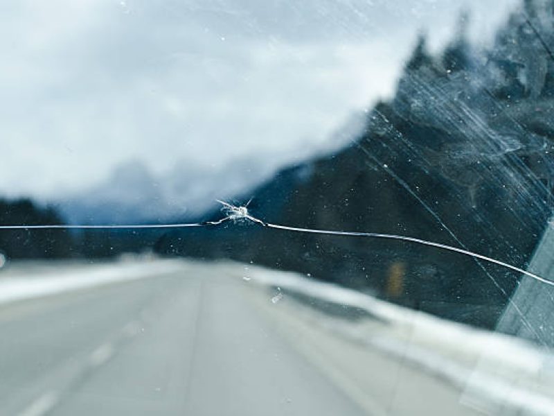 Cracked windshield close up on a highway